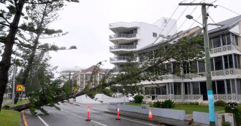 Thousands of Australians without power as ex-tropical cyclone lashes Queensland